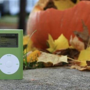 white ipod nano 4 th generation on gray concrete floor