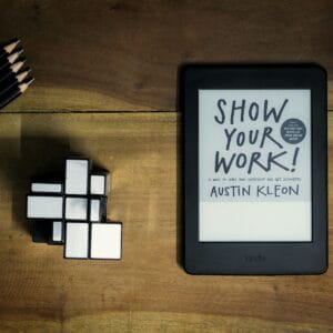 a tablet with a book titled show your work