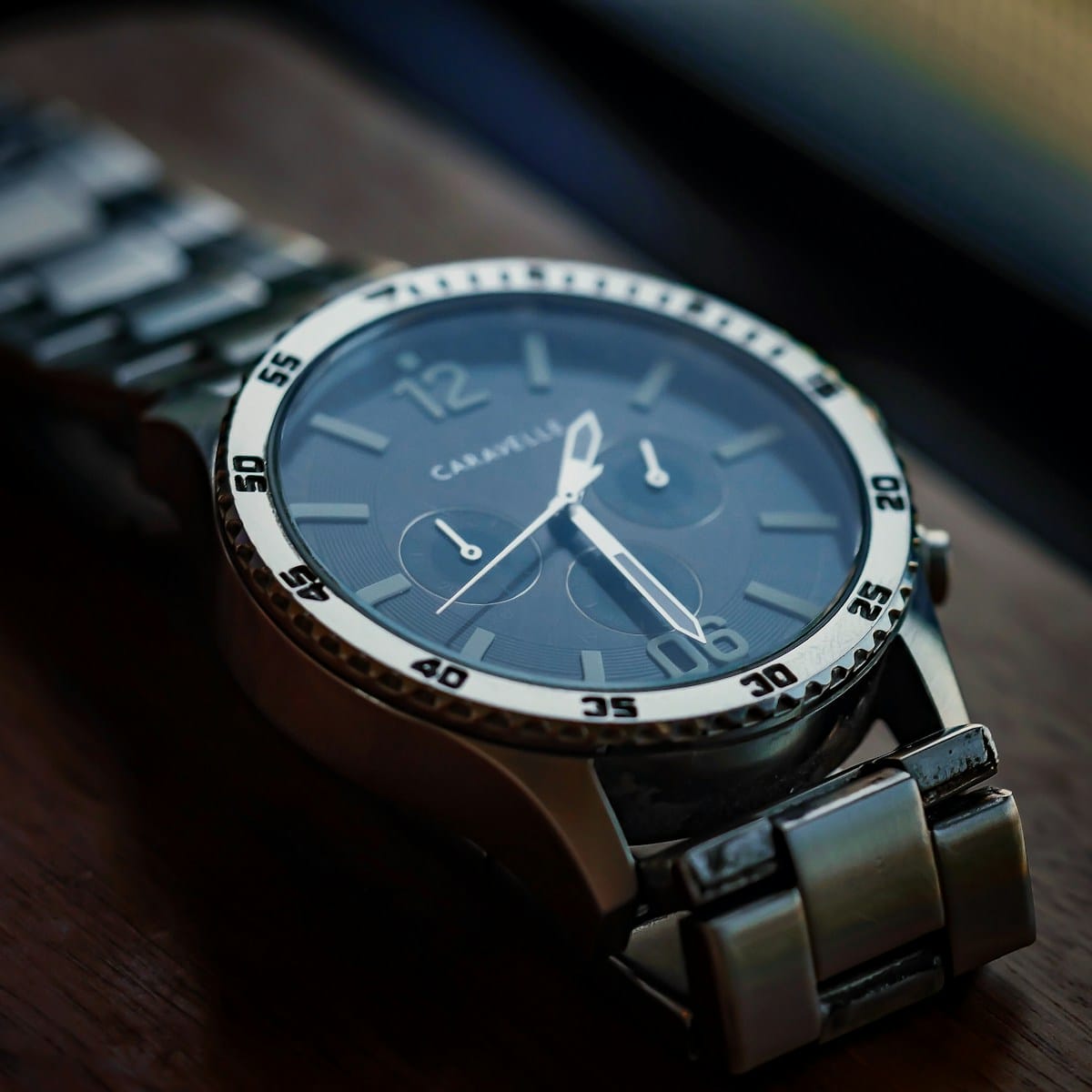 a watch sitting on top of a wooden table